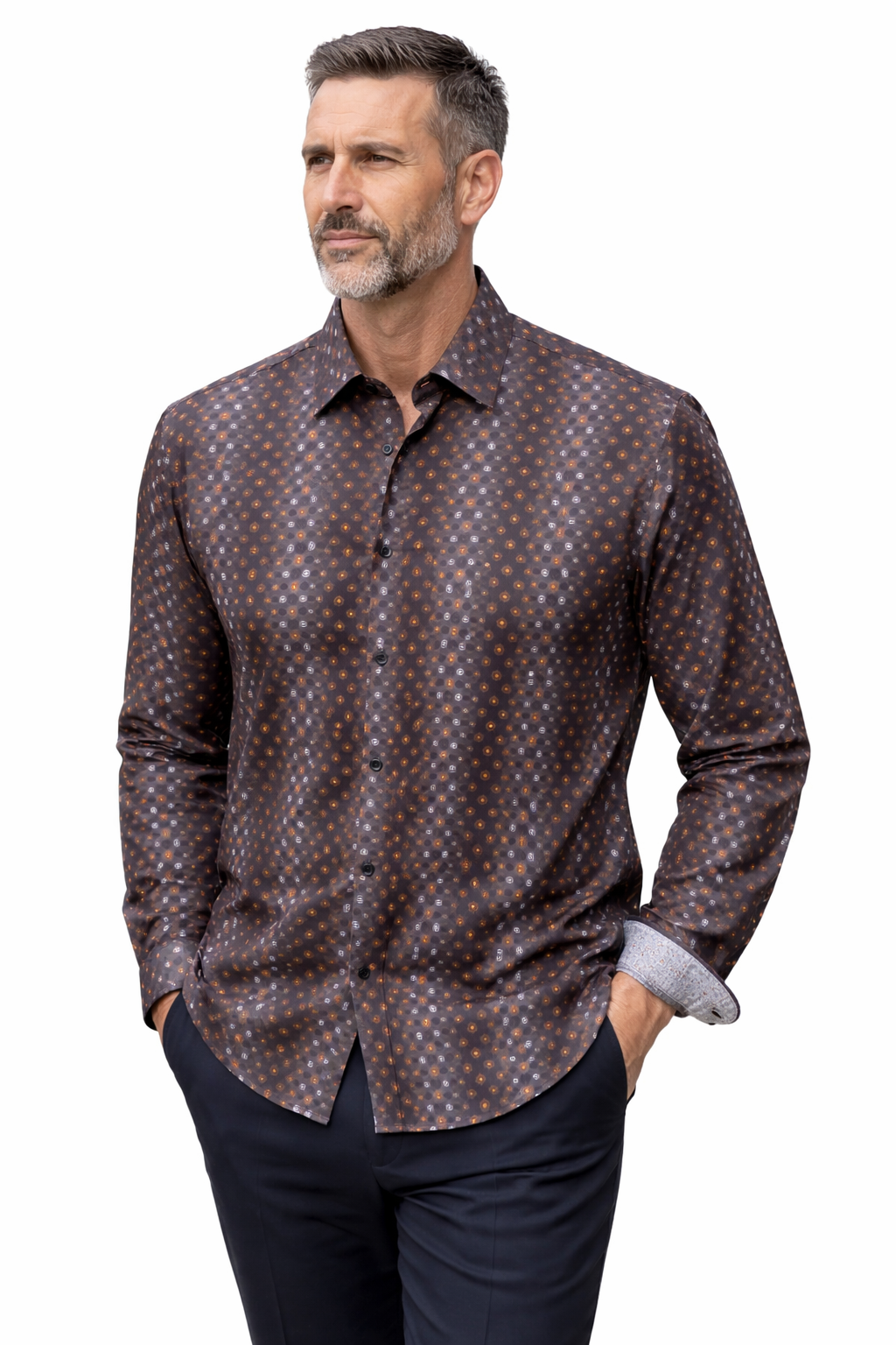 Man wearing a patterned brown shirt with rolled-up sleeves on a white background