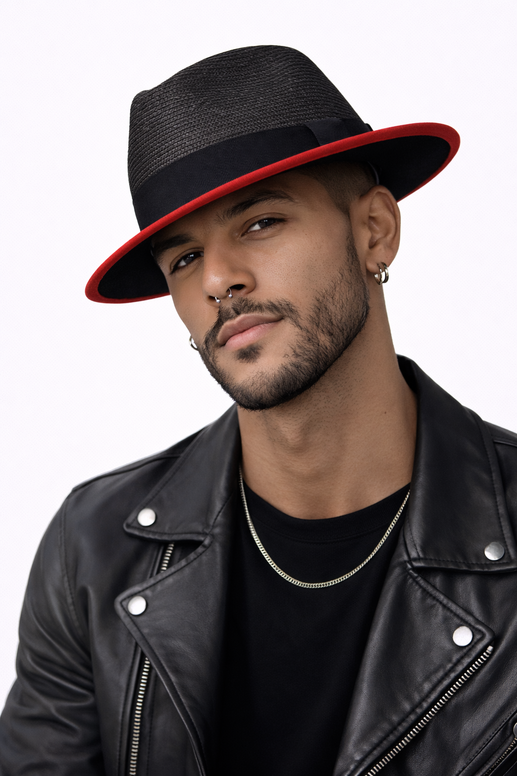 Man wearing a black fedora with red interior, black leather jacket, and black shirt on a white background
