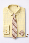 Yellow checkered shirt with a patterned tie and pocket square on a light gray background