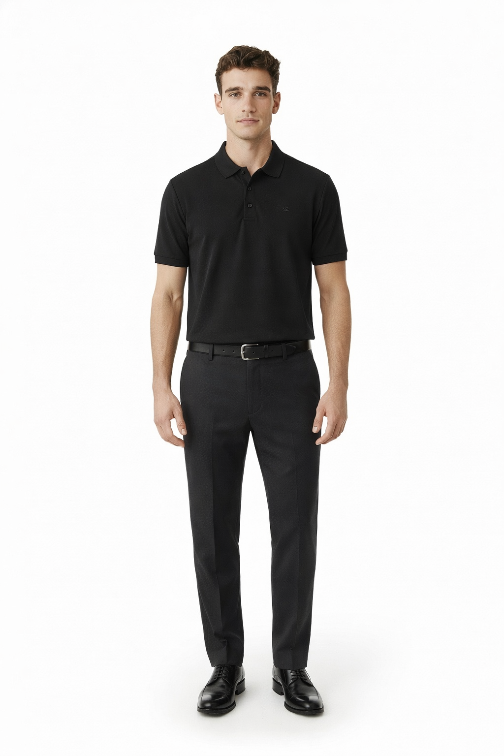 Man wearing a black polo shirt and black pants on a white background