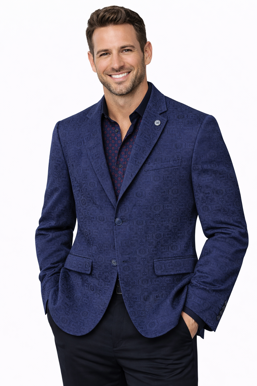 Man wearing a blue blazer over a dark shirt on a white background