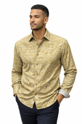Man wearing a patterned yellow shirt on a white background