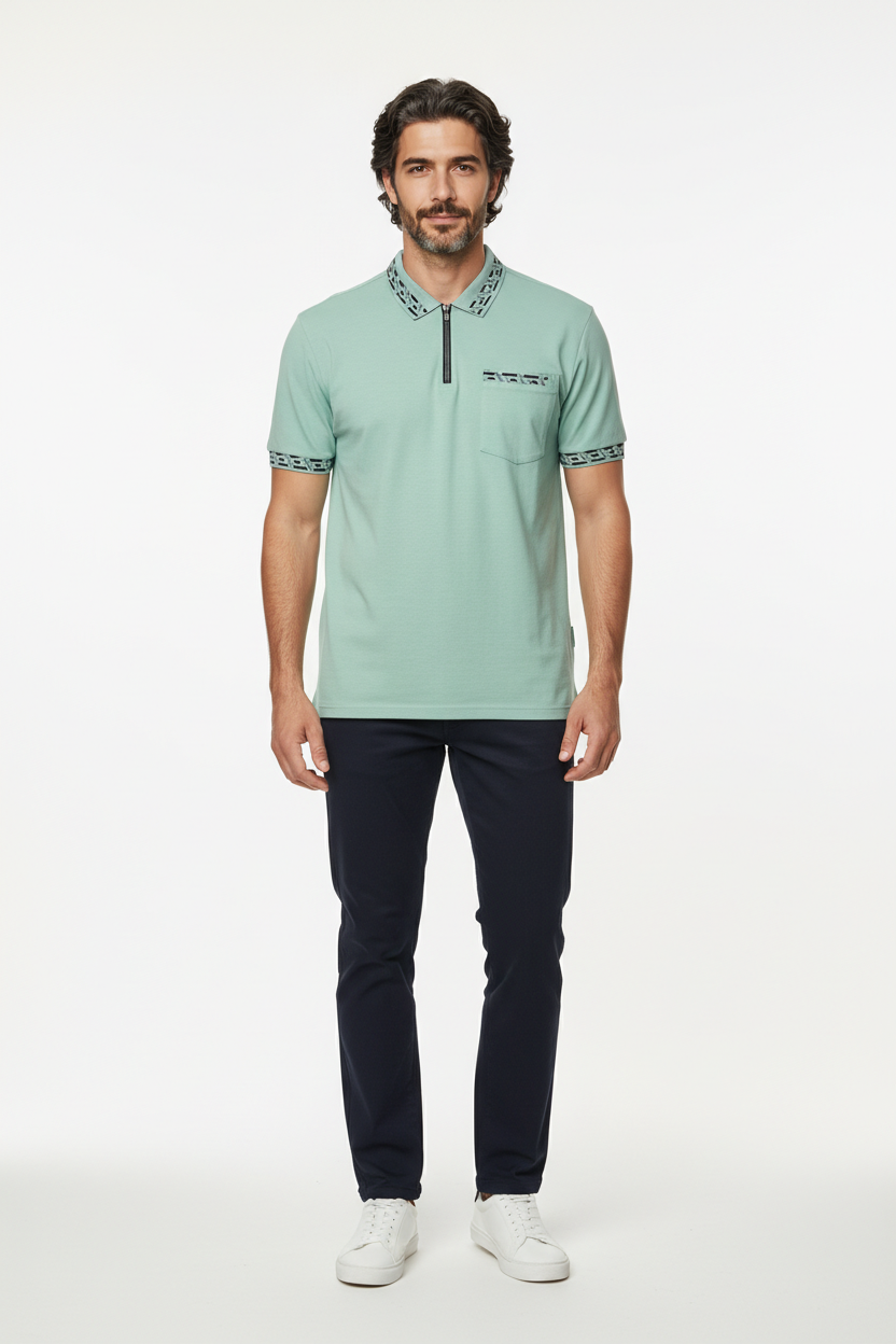 Man wearing a light green polo shirt with dark pants on a white background