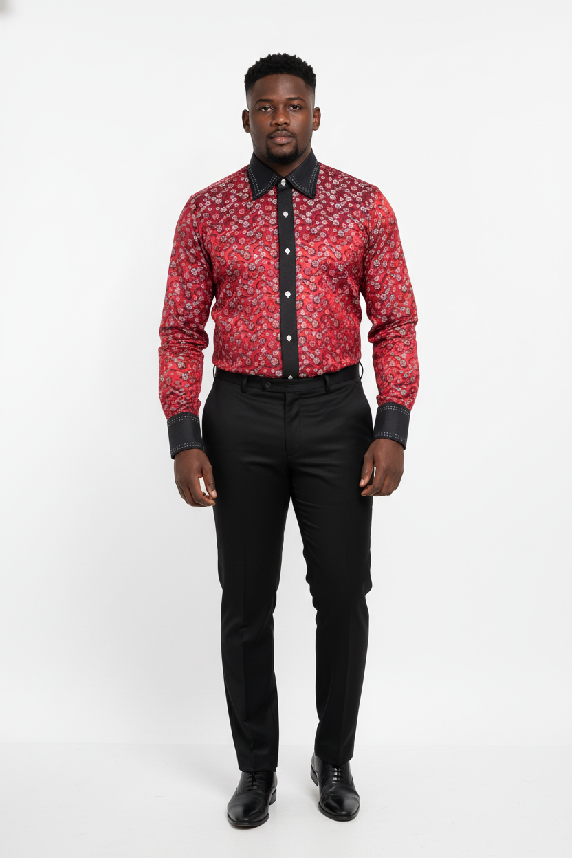 Man wearing a red patterned shirt with black trim and black pants on a white background