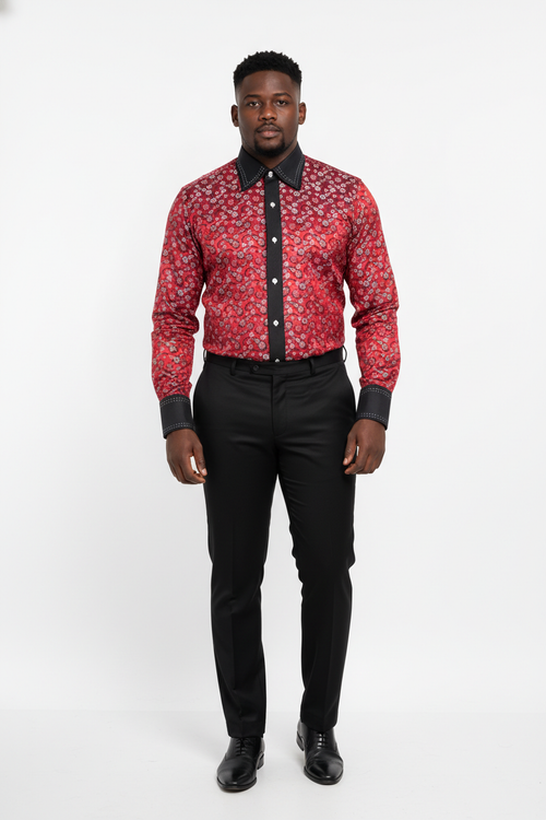 Man wearing a red patterned shirt with black trim and black pants on a white background